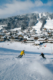 Two Skiers on the mountain above Les Gets in the Snow
